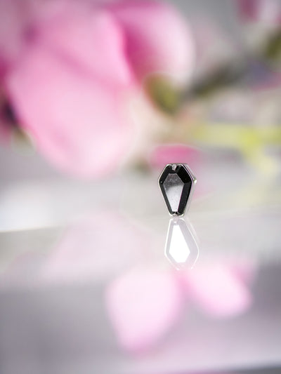 spooky black gem stone in the shape of a coffin