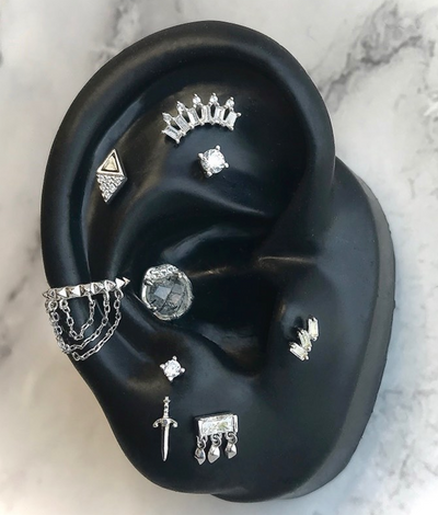 buddha jewelry ear project featuring persephone in conch, some prong set swarovski ends, the staxx in the tragus and a vision in the conch