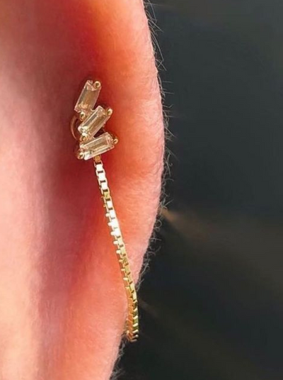 yellow gold buddha chain in cartilage piercing