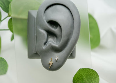 ear lobe piercing featuring small 14k gold zuri swarovski marquis cut stone threadless end
